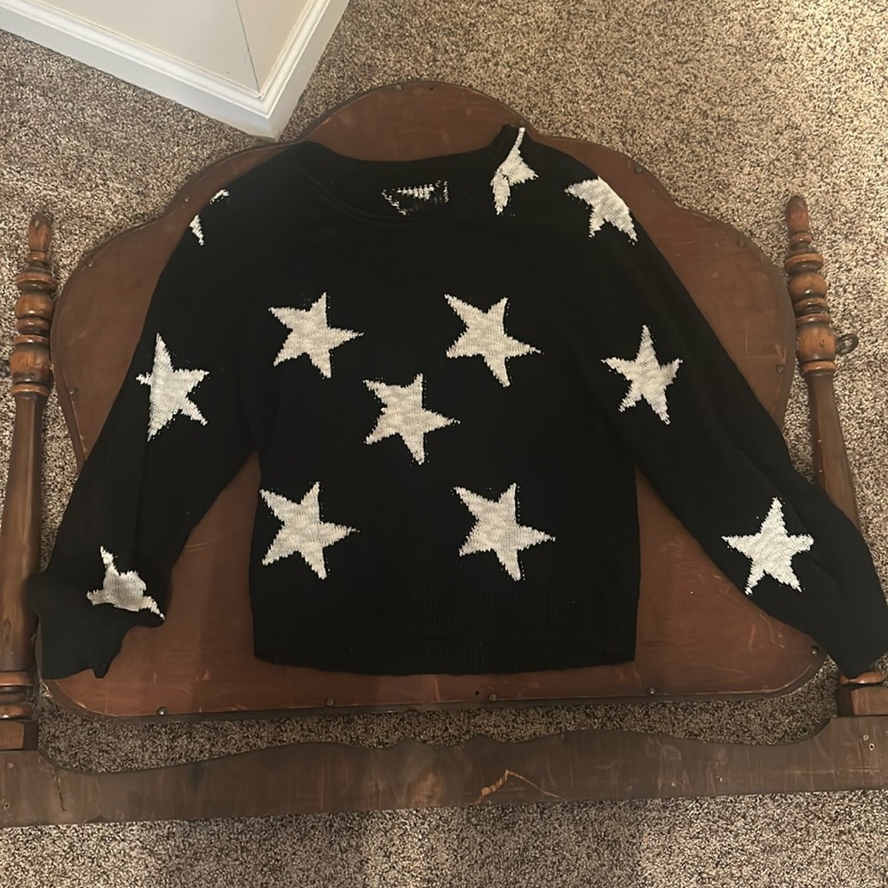 Black sweater with white stars.